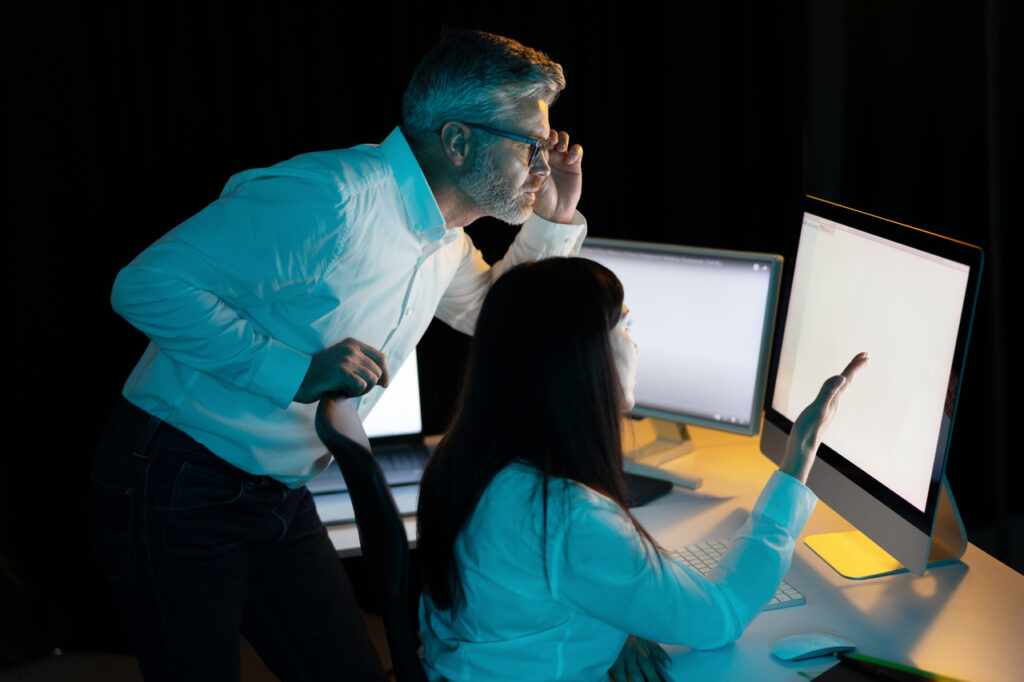 two people sitting in front of a computer discussing cyber incident readiness