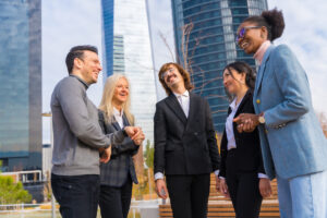 Businessmen and women speaking together and smiling